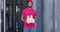 bearded african delivery man in red uniform with food lunch boxes and coffee