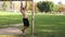 Bearded athlete making pull-up exercisings on a crossbar of football goal. 4K side view slow mo footage