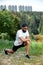 Bearded athletic man doing workout exercise in the outdoor gym in sunset