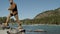 Bearded attractive hiker young tourist traveler man traveling jumping over stones mountain river forest