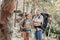 Bearded backpacker checking time on his black watch while hiking with girlfriend