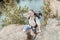 Bearded backpacker wiping sweat on his forehead feeling tired while hiking