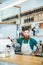 Bearded barista with tattooed hands in coffee shop