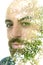 A bearded bold man and green tree branches photo double exposure portrait close up