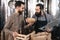 Bearded brewer is sniffing hops in beer basket at brewery. Checking quality of beer hops.