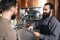 Bearded brewers inspect equipment of brewery for production of craft beer. Brewing. Brewery.