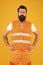 Bearded brutal hipster safety engineer. High visibility reflective safety vest. Man worker protective uniform orange