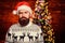 Bearded brutal hipster santa hat. xmas presents. male beard in warm winter knitted sweater. serious santa man at