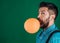 Bearded brutal man. brutal caucasian hipster with moustache. male with beard. man. surprised man with orange balloon