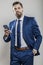 Bearded business man in blue suit operates smart phone