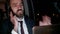 Bearded businessman in business suit having a phone call