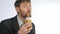 Bearded businessman having healthy lunch, guy drinks vegetable smoothies. slow motion