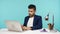 Bearded businessman or life coach in elegant suit keeping online conference at laptop sitting in his office, brainstorming