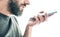 Bearded caucasian man recording voice message or using voice assistant on mobile phone