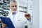 Bearded Caucasian pharmacist in a white coat counting medicines in a drugstore