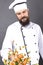 Bearded chef flipping vegetables in a frying pan