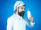 Bearded chef man in uniform with bottle of milk. Drinks, dairy farmer products, diet.