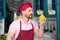 Bearded Chef in rose t-shirt sniffing yellow paprika on kitchen