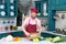 Bearded Cook in apron and cap puts off mushrooms from wooded cutting board