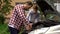 Bearded dad and his son repairing car with open hood outdoors, fixing engine