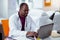 Bearded dark-skinned medical scientist working on laptop