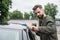 Bearded driver cleaning blurred car with