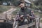 Bearded farmer brushing a donkey on cattle-farm