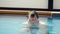 Bearded fat man swims in swimming pool