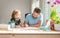 bearded father writing school homework with his boy son in classroom, homework