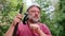 A bearded fisherman prepares a fishing rod. Close-up