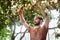 bearded gardener in linen apron cutting