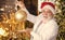 Bearded grandfather senior man celebrate christmas. Kind grandpa with toy. Sparkling decorations. Decorating home