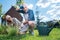 Bearded grey-haired man mopping his brows after working hard near garden bed