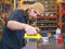 Bearded guy waxing ski in the workshop