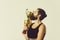 Bearded happy man kissing gold champion cup on grey background