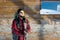 Bearded hiker in front of log cabin