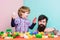 Bearded hipster and boy play together. Dad and child build plastic blocks. Child care concept. Happy family. Child