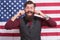 Bearded hipster man being patriotic for usa. American education reform at school in july 4. American citizen at USA flag
