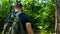 Bearded hipster man walking on the forest road. Adventure hikes. Holiday.