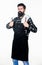 Bearded hipster wear apron for barbecue. Roasting and grilling food. Man hold cooking utensils barbecue. Tools for