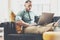 Bearded Hipster working Laptop modern Interior Design Loft Office.Man work Vintage Sofa,Use contemporary Notebook,typing