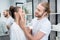 Bearded husband applying face cream on cheek of his wife in bathroom