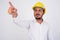 Bearded Indian businessman with hardhat pointing finger and directing