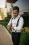 Bearded Indian Muslim man adjusting watch wearing suspenders