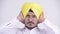 Bearded Indian Sikh businessman showing hear no evil concept