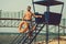 Bearded lifeguard or muscular man with orange ring buoy