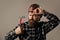 bearded male hipster in checkered shirt and laborer helmet, working