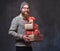 Bearded male holds Christmas gifts.