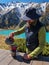 Bearded male tourist preparing coffee while camping high in the mountains