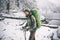 Bearded Man with backpack hiking in winter forest